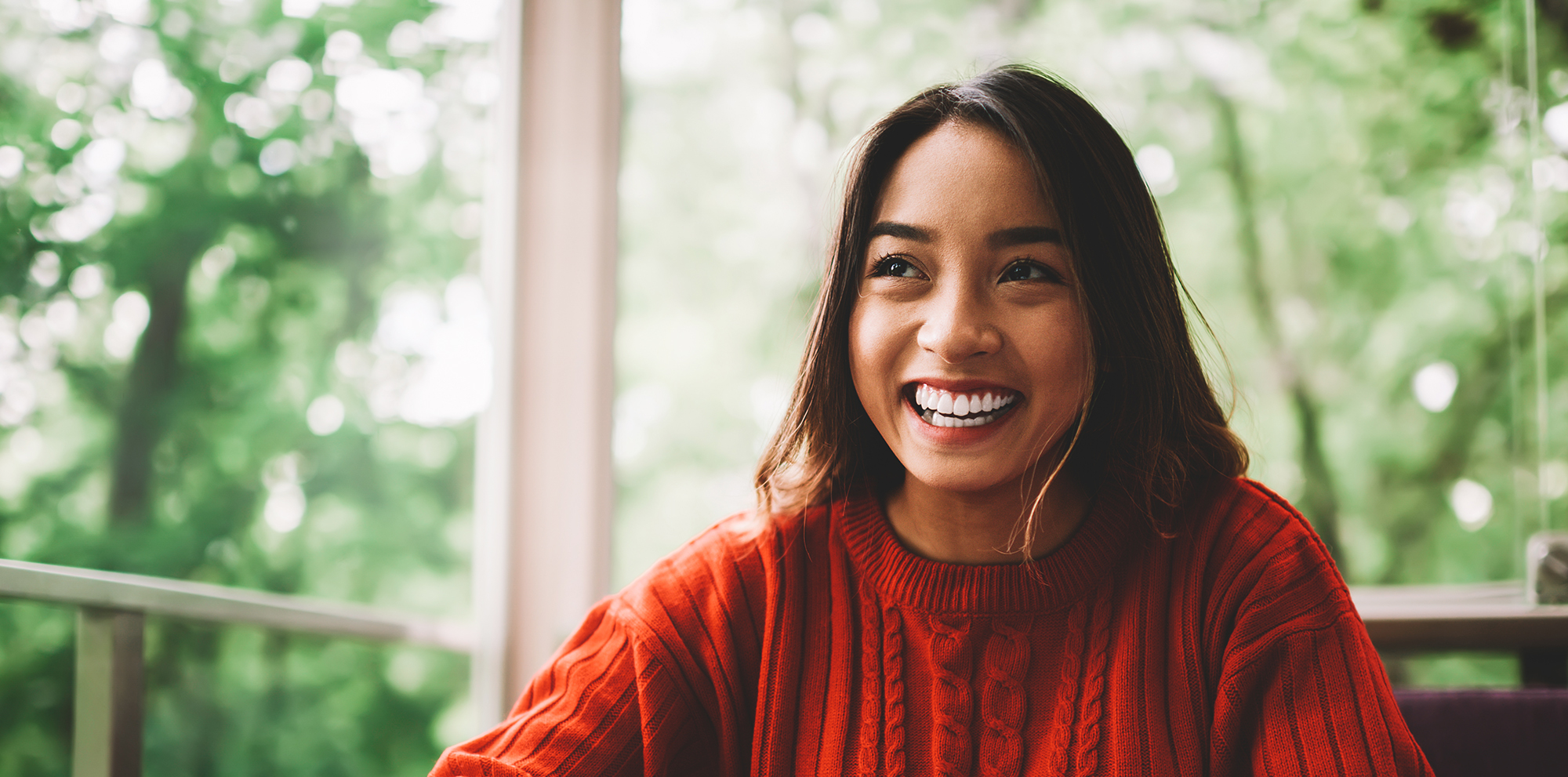Smiling Professional in orange sweater