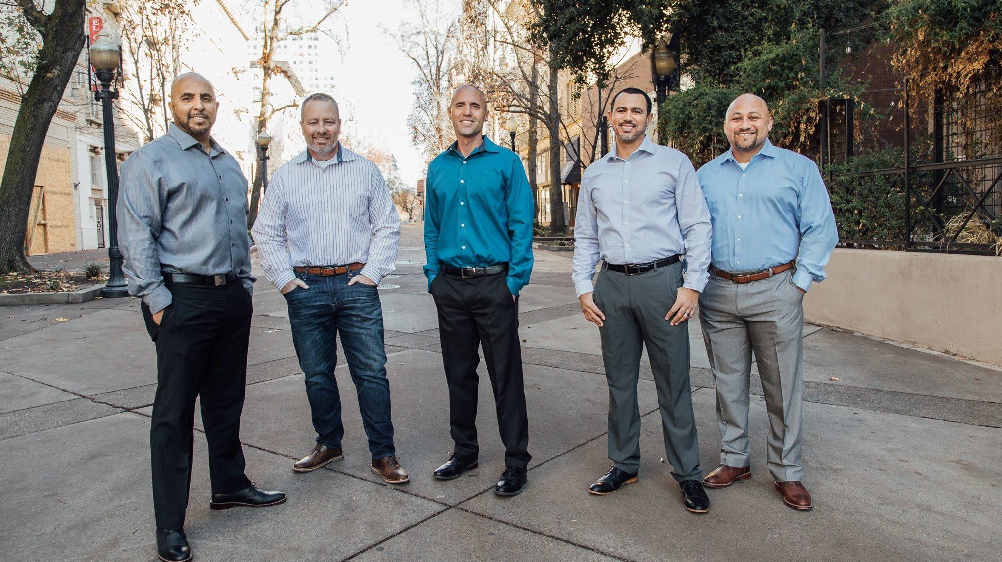 The five founders of CROP Organization stand outside