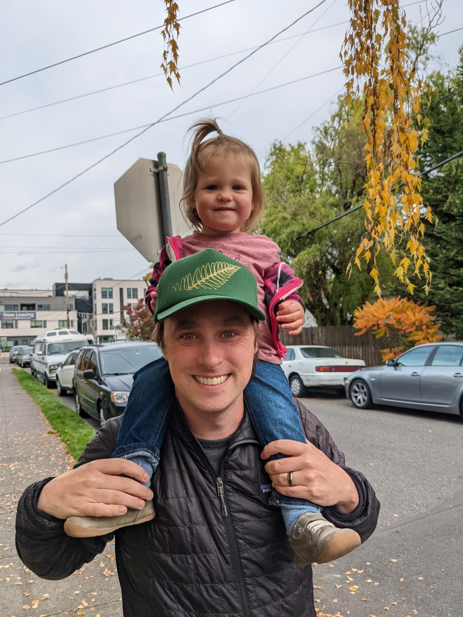 Craig Hill with his daughter Eleanor on his shoulders in a Portland neighborhood