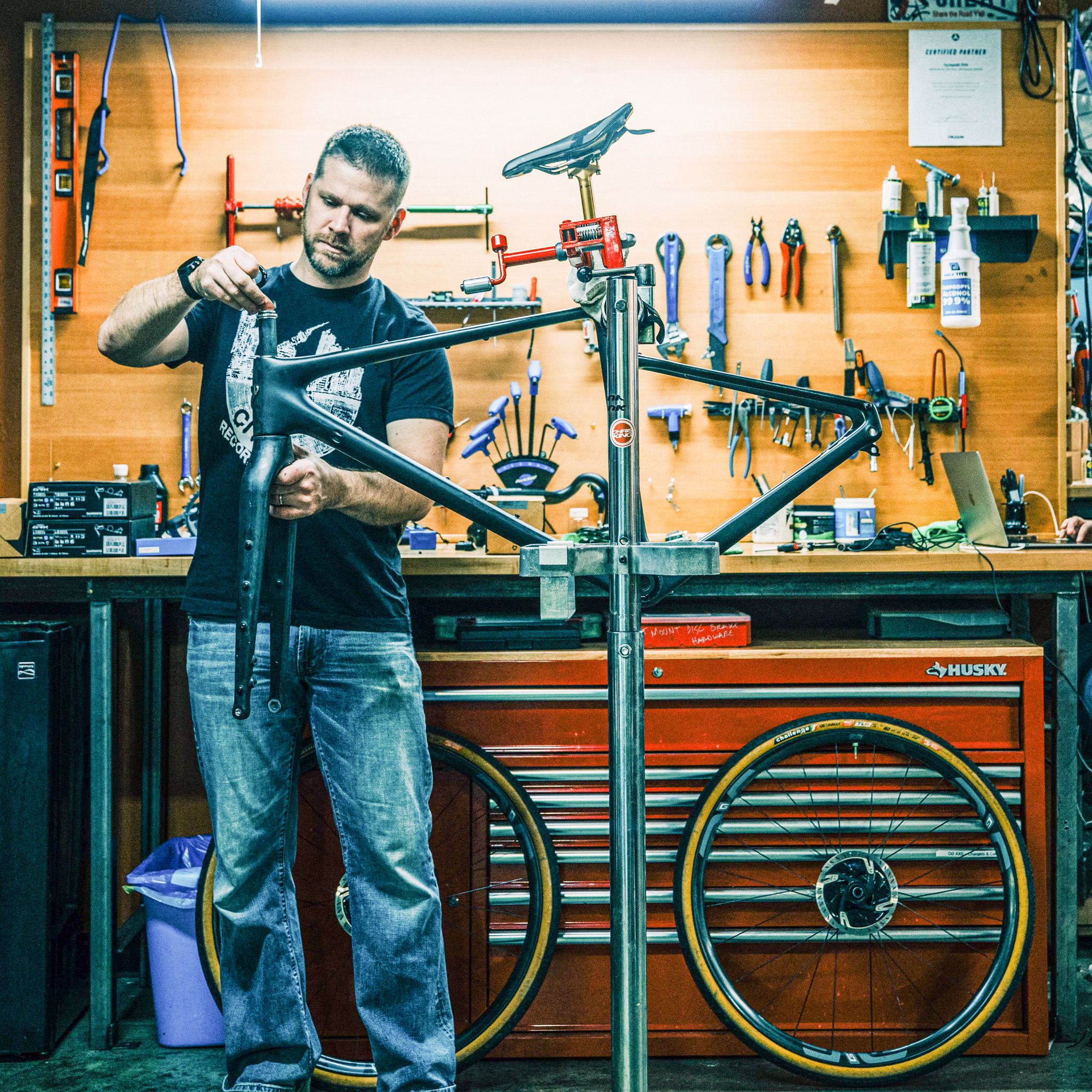 A man works on a bicycle repair at Cyclepath PDX, a locally owned and operated bike shop in NE Portland.