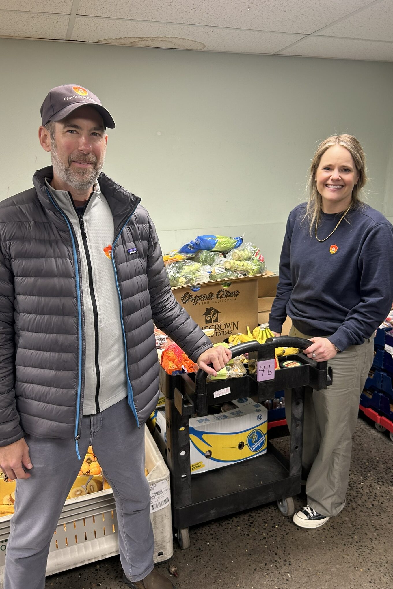 Two Beneficial State Bank employees volunteering sorting food donations