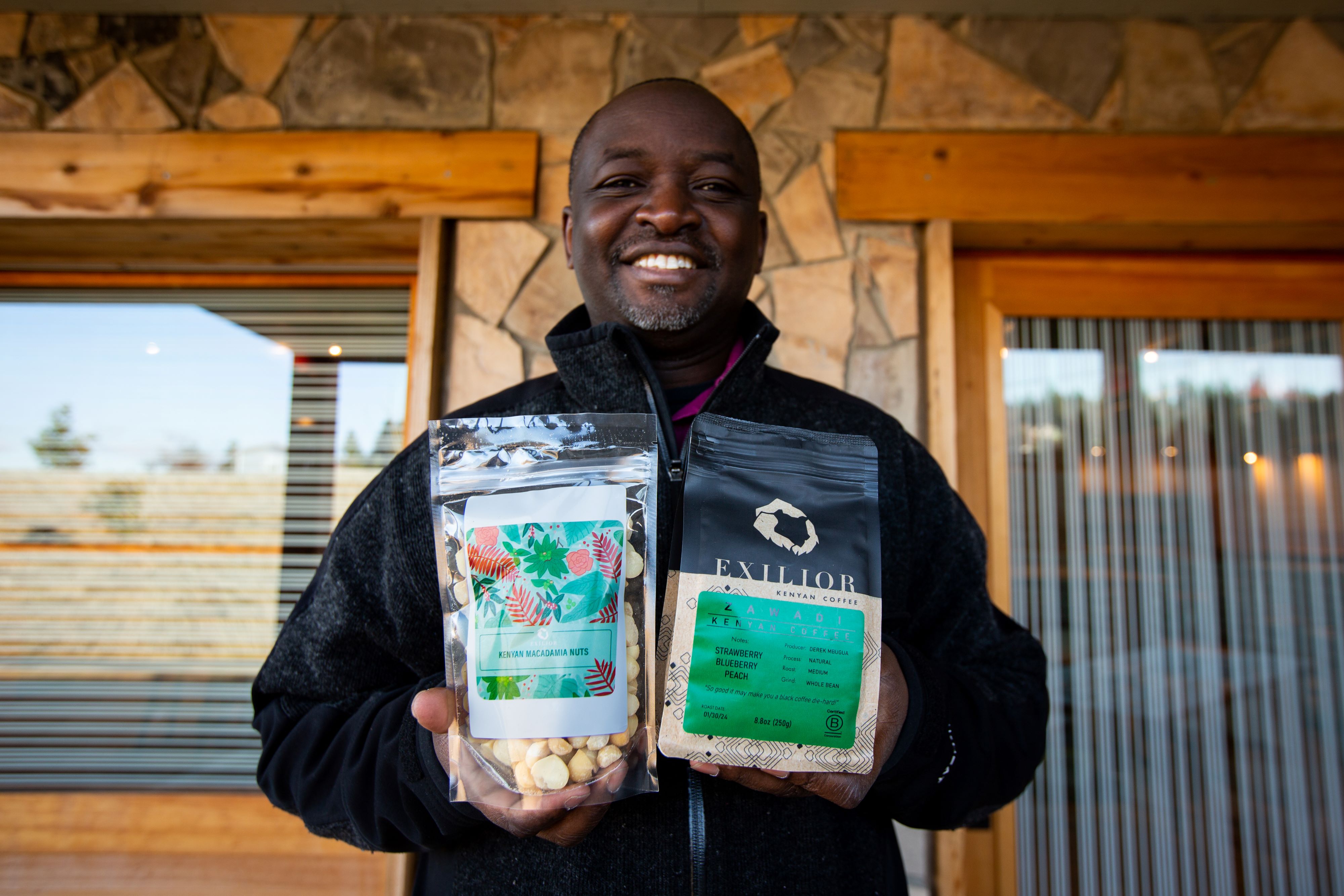 Francis Kungu, Co Founder of Exilior Coffee, holds coffee bags.
