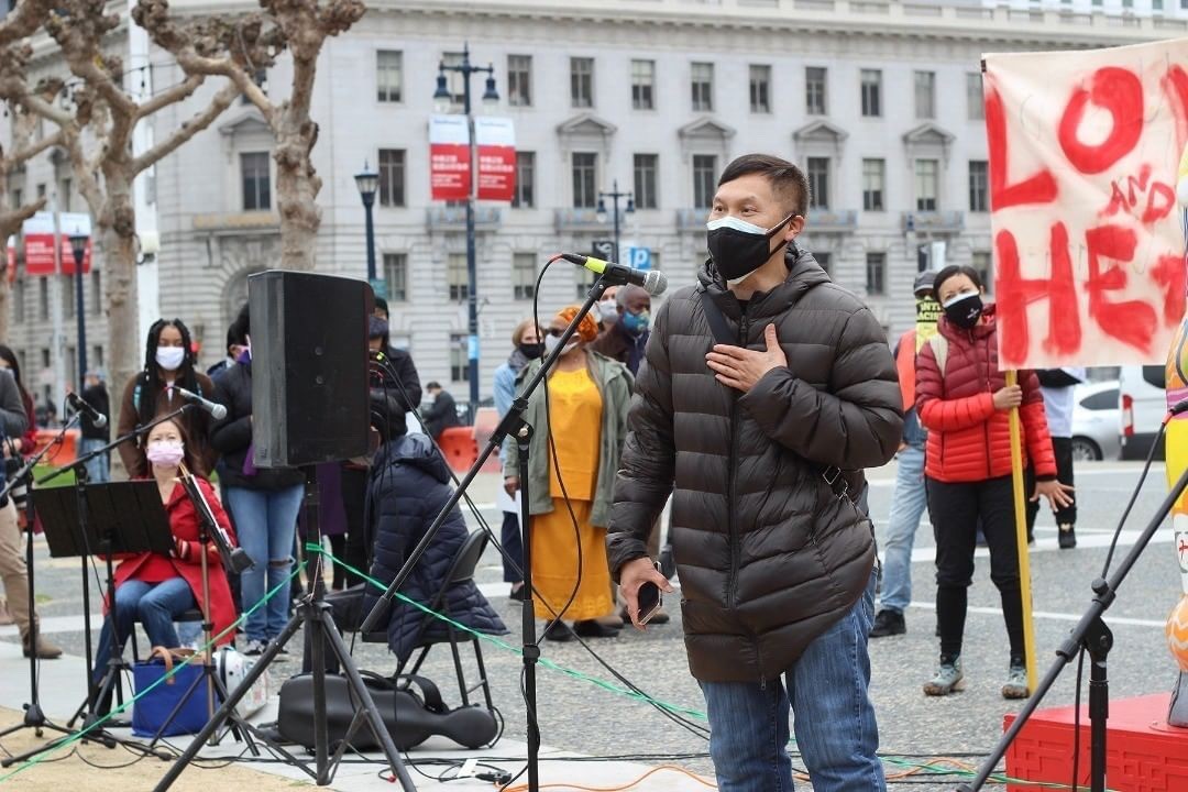 man at microphone at rally