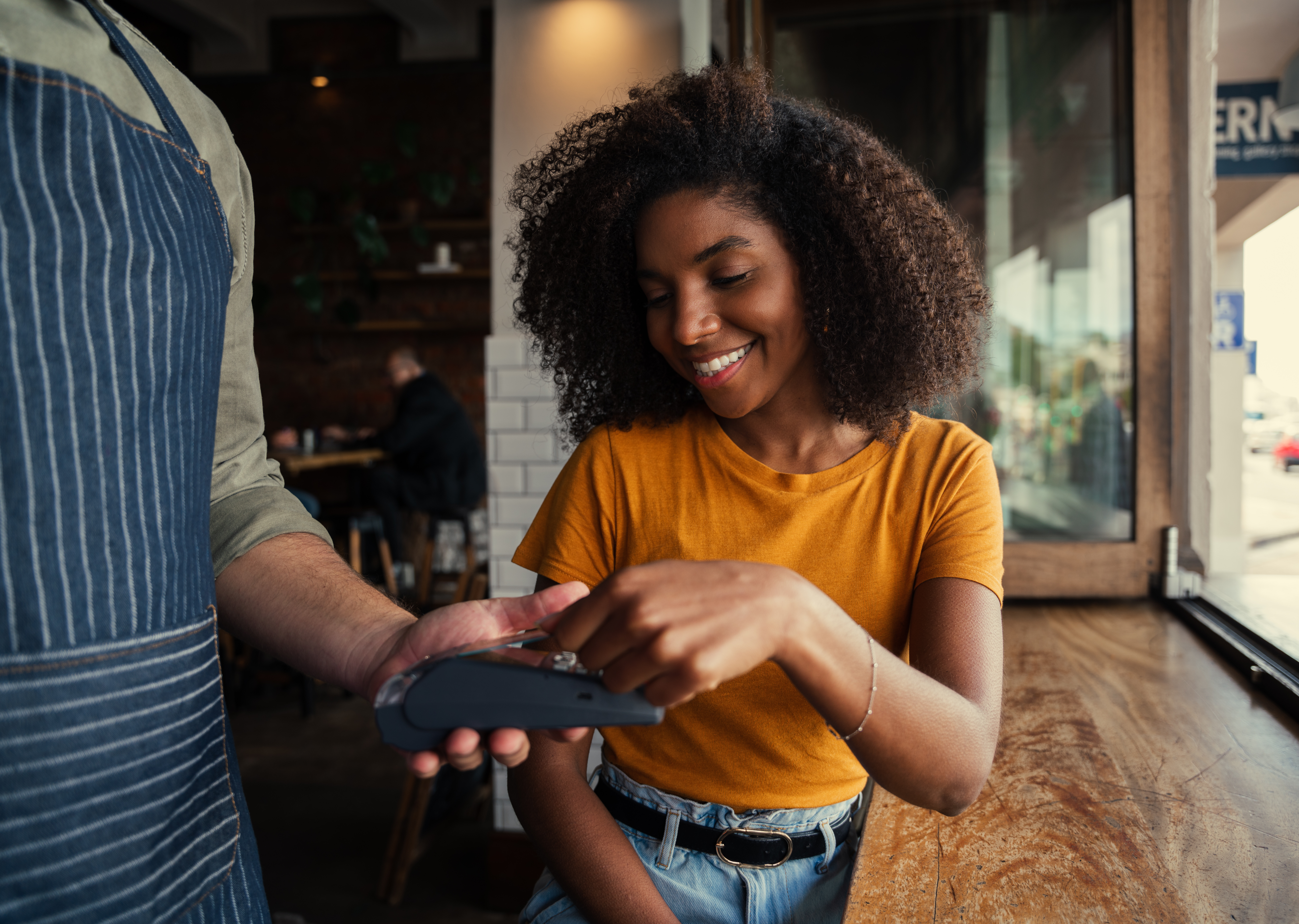 Woman Paying with Credit Card at Restaurant