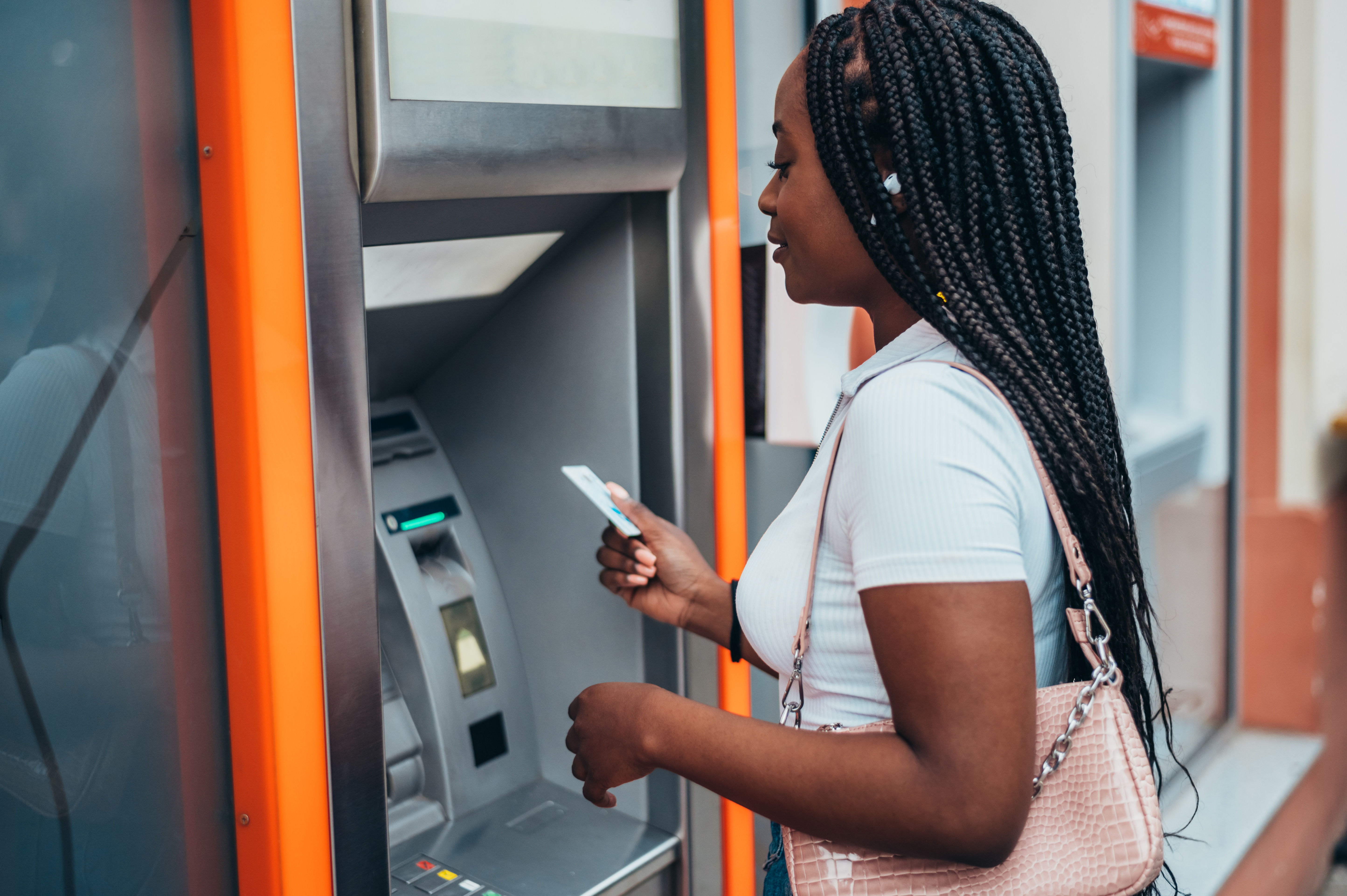 Woman Using Debit Card at ATM
