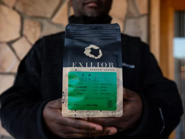 Francis Kungu holds a bag of Exilior Coffee
