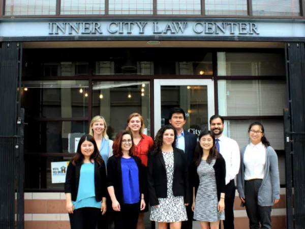 Summer interns stand in front of the Inner City Law Center Building.