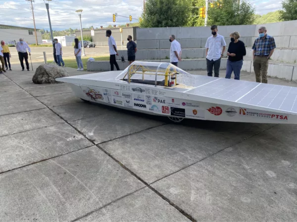 Raisbeck High School's solar car with onlookers standing in the background