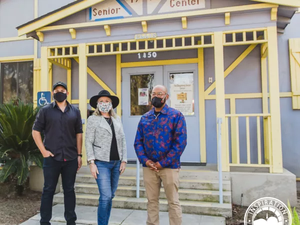 Three people in masks standing in front of the Senior Center in Kingsburg, California