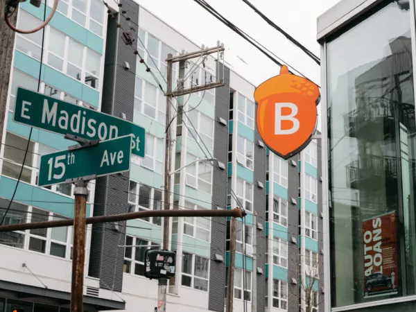 A photo outside our Seattle branch in the Bullitt Center, showing our logo and the cross streets E Madison St and 15th Avenue.