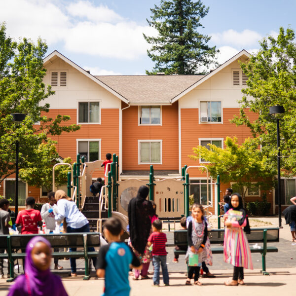 A group of kids and adults on a playground A group of kids and adults on a playground