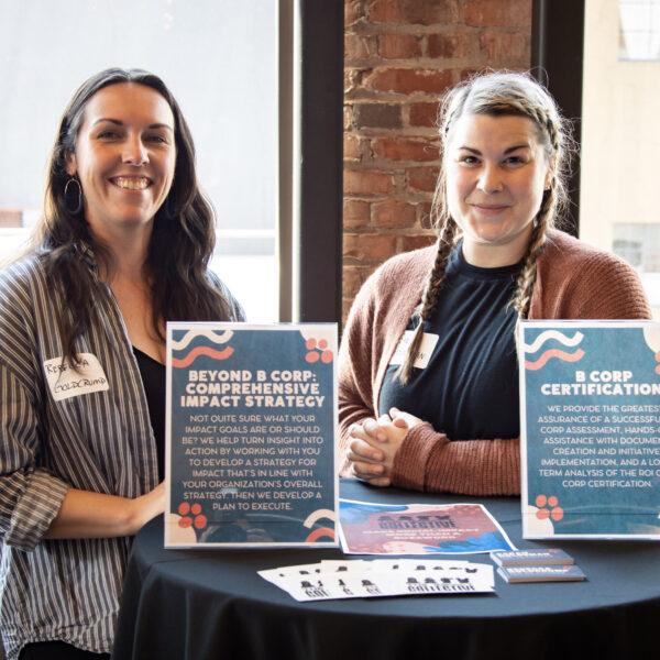 Rebecca Goldcrump and Sarah Holdeman of The Impact Collective tabling at an event