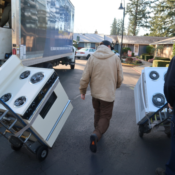 Two new ranges are being transported toward the affordable housing apartment complex for installation.