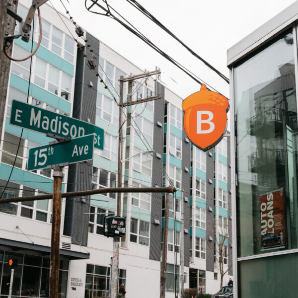 A photo outside our Seattle branch in the Bullitt Center, showing our logo and the cross streets E Madison St and 15th Avenue.