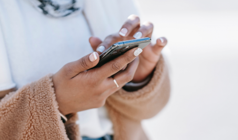 Woman's hands holding a cellphone